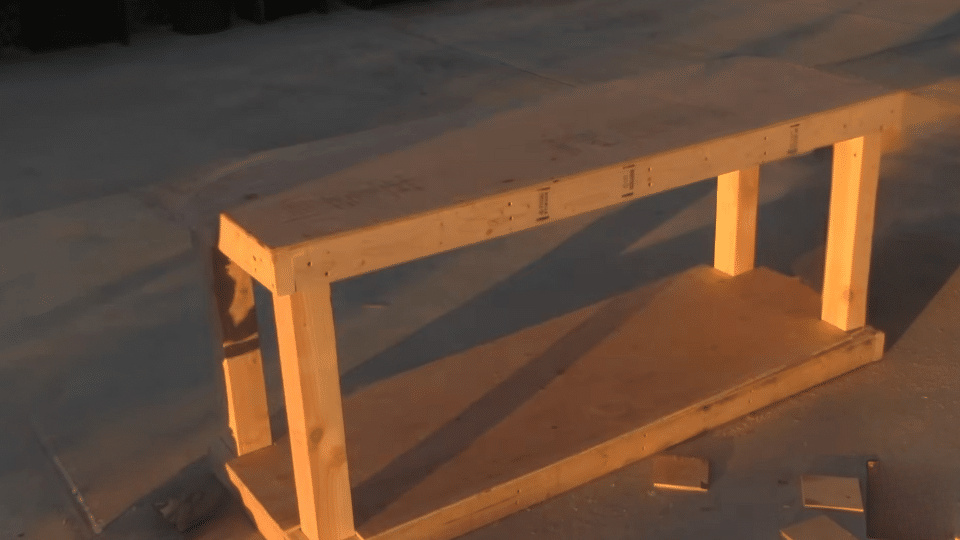 cutting and attaching the plywood to build a diy workbench