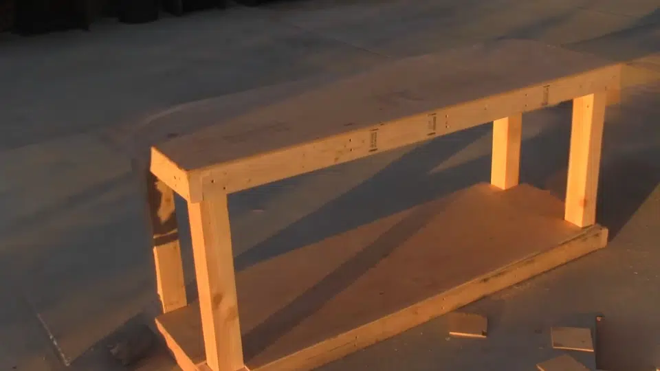cutting and attaching the plywood to build a diy workbench