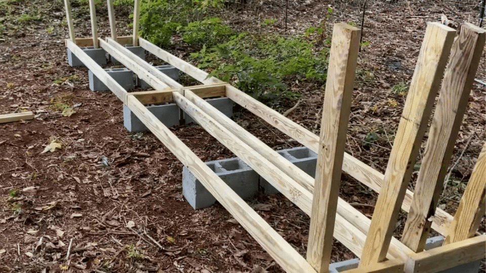 add vertical supports to diy firewood rack